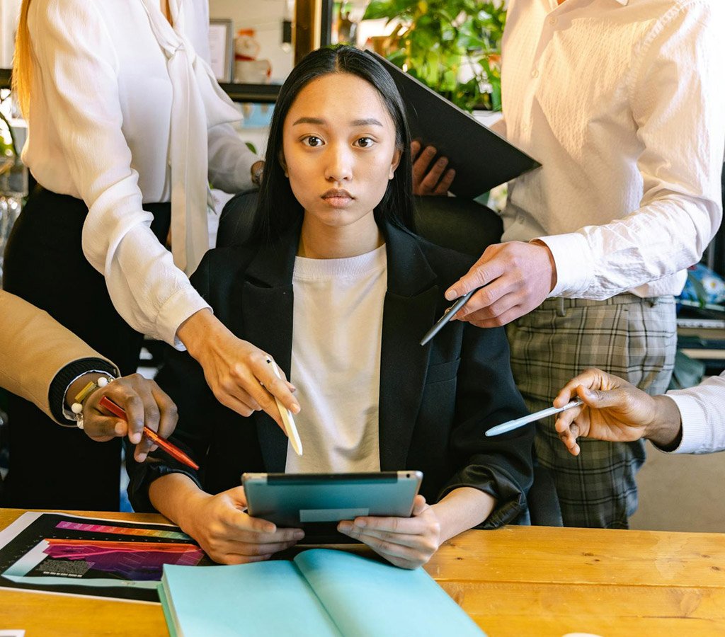 A lady at work under pressure from her team members