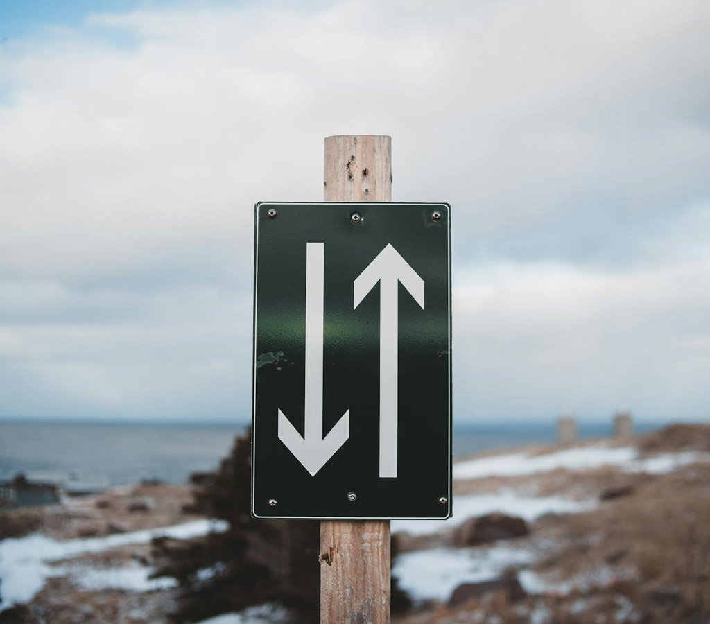 Road sign up and down arrows illustrating difficulty finding meaning from grief and loss